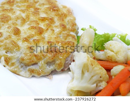 Baked cutlet with cauliflower and carrot garnish, isolated food still life, close up