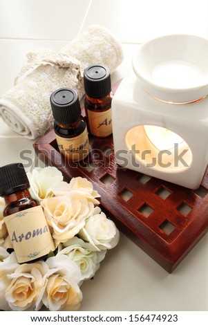 Aromatherapy lamp with oil bottle and roses