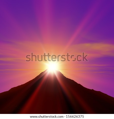 Sun flare on peak of mountain with dramatic sky
