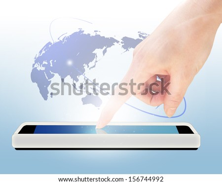 Closeup of hand using digital tablet in front of world map