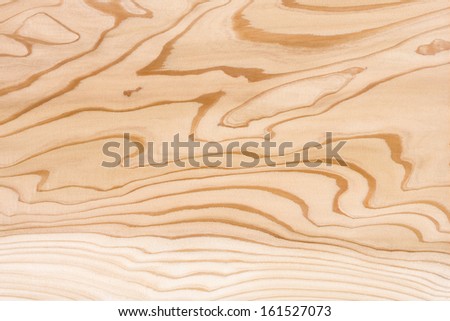 A wood surface with dark wavy grain.