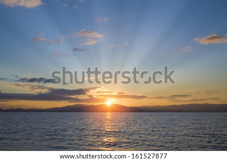 Sun rays over a large bed of water.