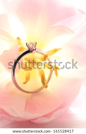 Diamond ring in the middle of a flower.