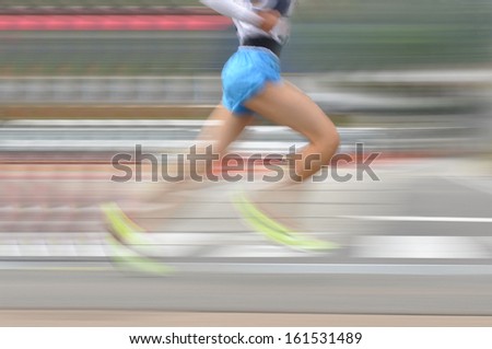 Lower body of a runner wearing shorts.