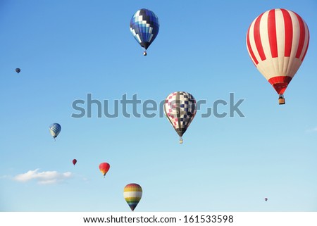 Colorful hot air balloons flying on a sunny day.