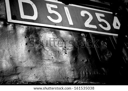 A black and white sign with letters and numbers.