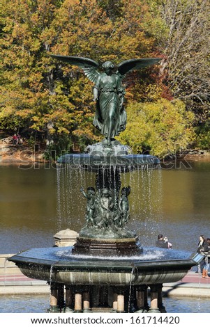 A bronze statue of an angel with water.