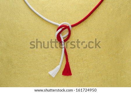 A red string and a white string tied together.