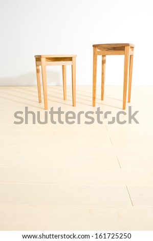 Two wooden tables of different height.