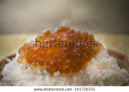 Steaming hot dish of rice and sauce.