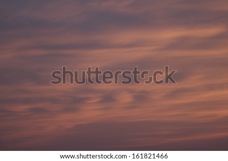 A view of the sky with red clouds in the background.