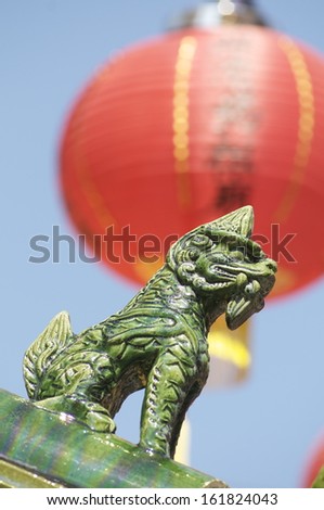 A green Chinese dragon statue.