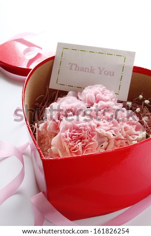 Pink marzipan flowers in heart shaped box with label