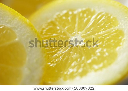 A juicy lemon cut in half so that there are two halves.