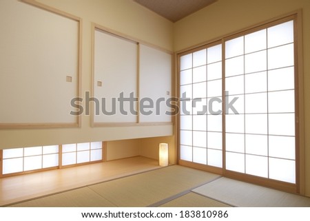 A corner of a large room with a wall of windows.