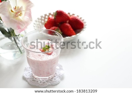A dessert drink served with fresh red strawberries.
