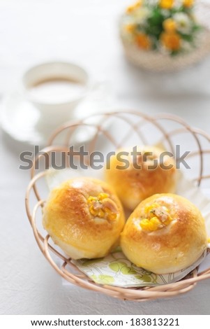 Three delicate puff pastries sitting in a wire basket.