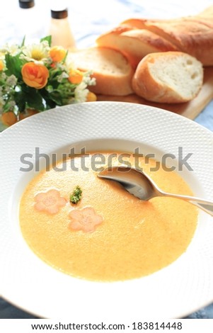 A beautifully accented soup and bread dinner in a simple bowl.