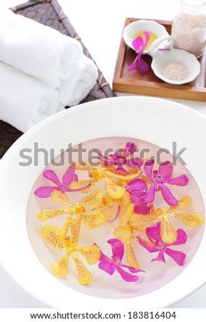 Flower petals on white plate and white towels.