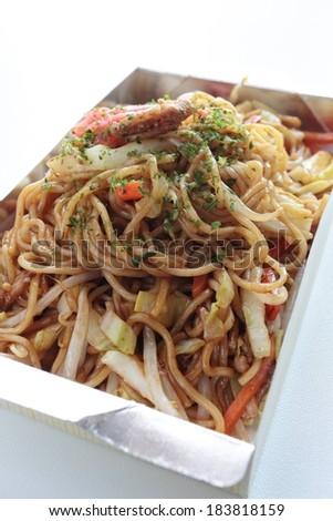 A large silver lined take out container with noodles and vegetables.
