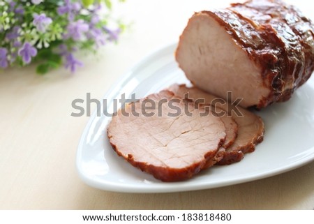 A piece of meat with three pieces sliced from it.