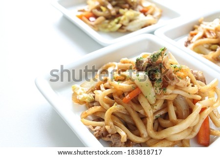 Three square white dishes with noodles and vegetables in them.