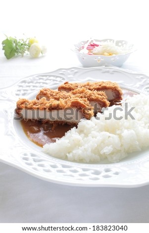 Three slices of breaded meat and a pile of rice.