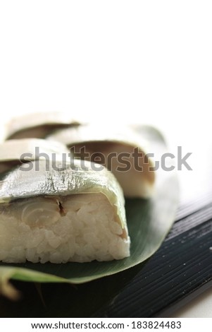 Four pieces of small portioned food displayed on a black surface.