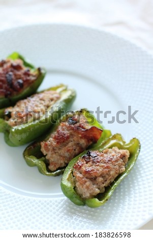 Two green peppers cut in half stuffed and baked.