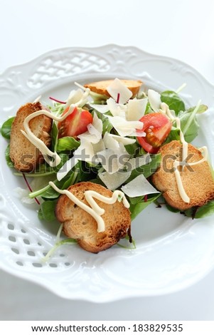 Tomato and spinach salad, resting in a bowl with toast.