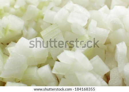 Several pieces of white onion chopped into small squares.