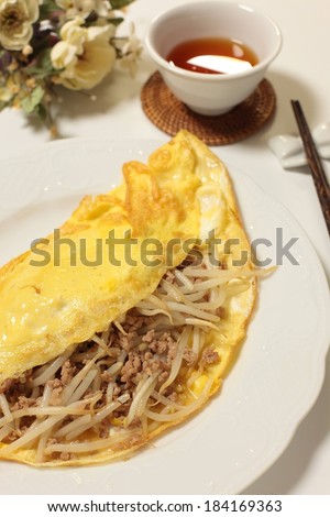 A meal of ground beef, grated cheese encased in a fried tortilla with dipping sauce.