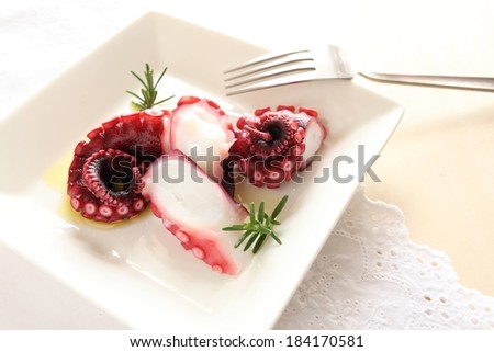 A sliced octopus sitting on a white plate.