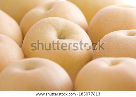 Golden yellow apples with small white spots sitting stems up.