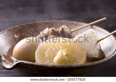 A brown bowl with pineapple, meat and an egg.