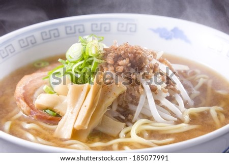 A round bowl full of a noodle like stew.