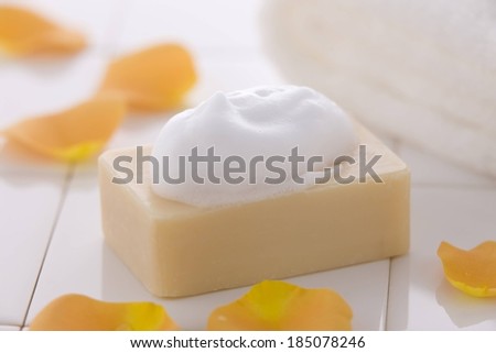 A soapy bar of soap sitting on a counter.