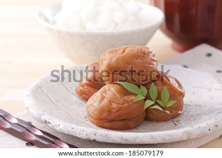A plate holding four food items with a garnish.