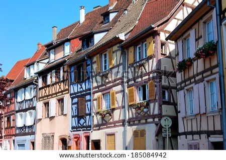 Several different colorful half-timber, medieval houses sitting beside each other in Europe.