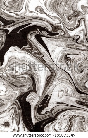 Marbled swirls of gray, white and black against a black background.