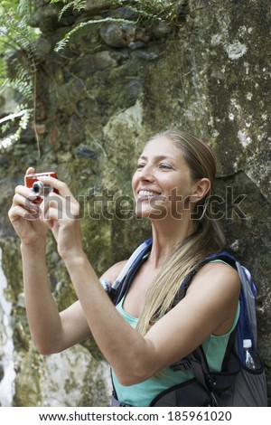 Female hiker taking photograph