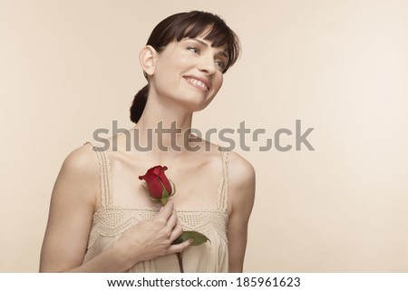 Mid adult woman holding rose