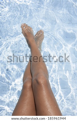 Woman\'s feet in water (focus on feet)