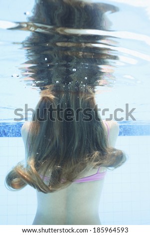 Mid adult woman diving (underwater view)