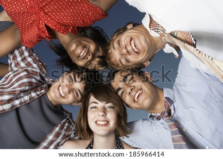 Five teenagers in a huddle (directly below)