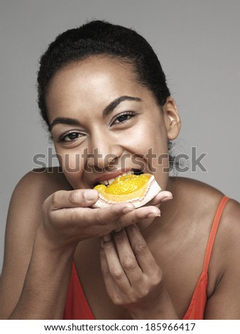 Young woman eating cupcake