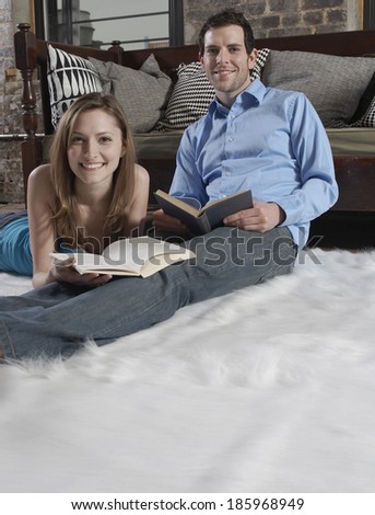 Mid-Adult Couple Reading on Floor