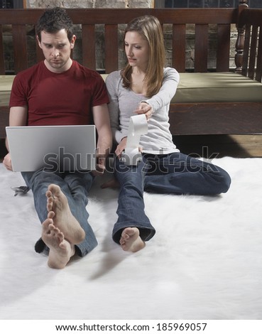 Worried Couple With Dirty Feet Managing Finance