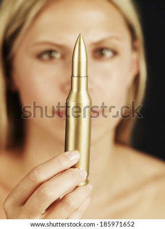 Mid-Adult Woman Holding Golden Bullet