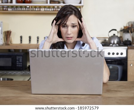 Worried Mid-Adult Woman Using Laptop